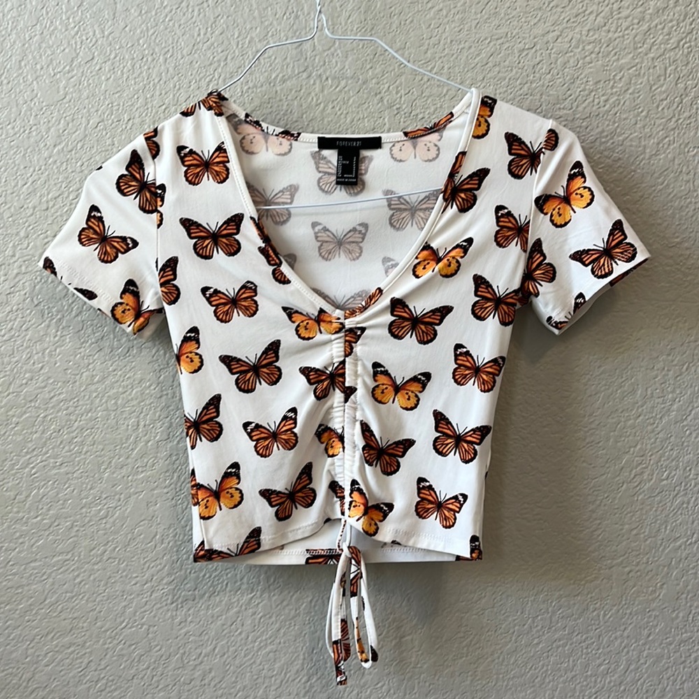 Orange butterfly t-shirt that ties at the bottom.